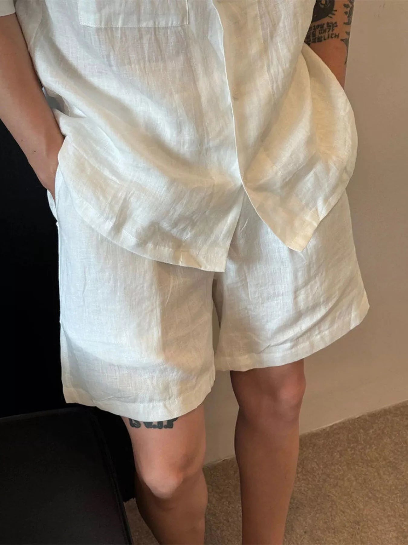 Men's white lightweight casual shorts with pockets.