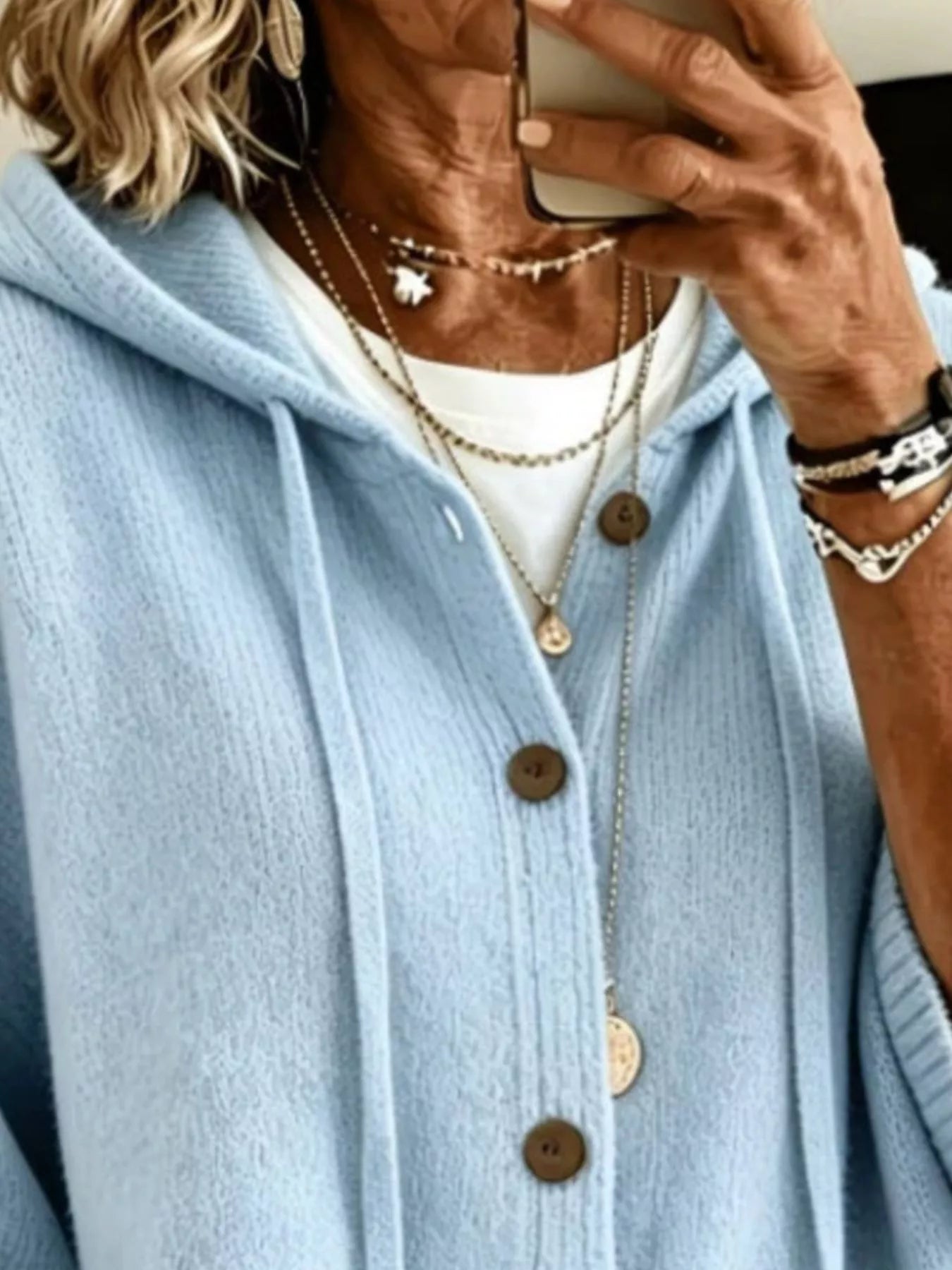 Close view of the sky blue hooded cardigan showing drawstrings and button front