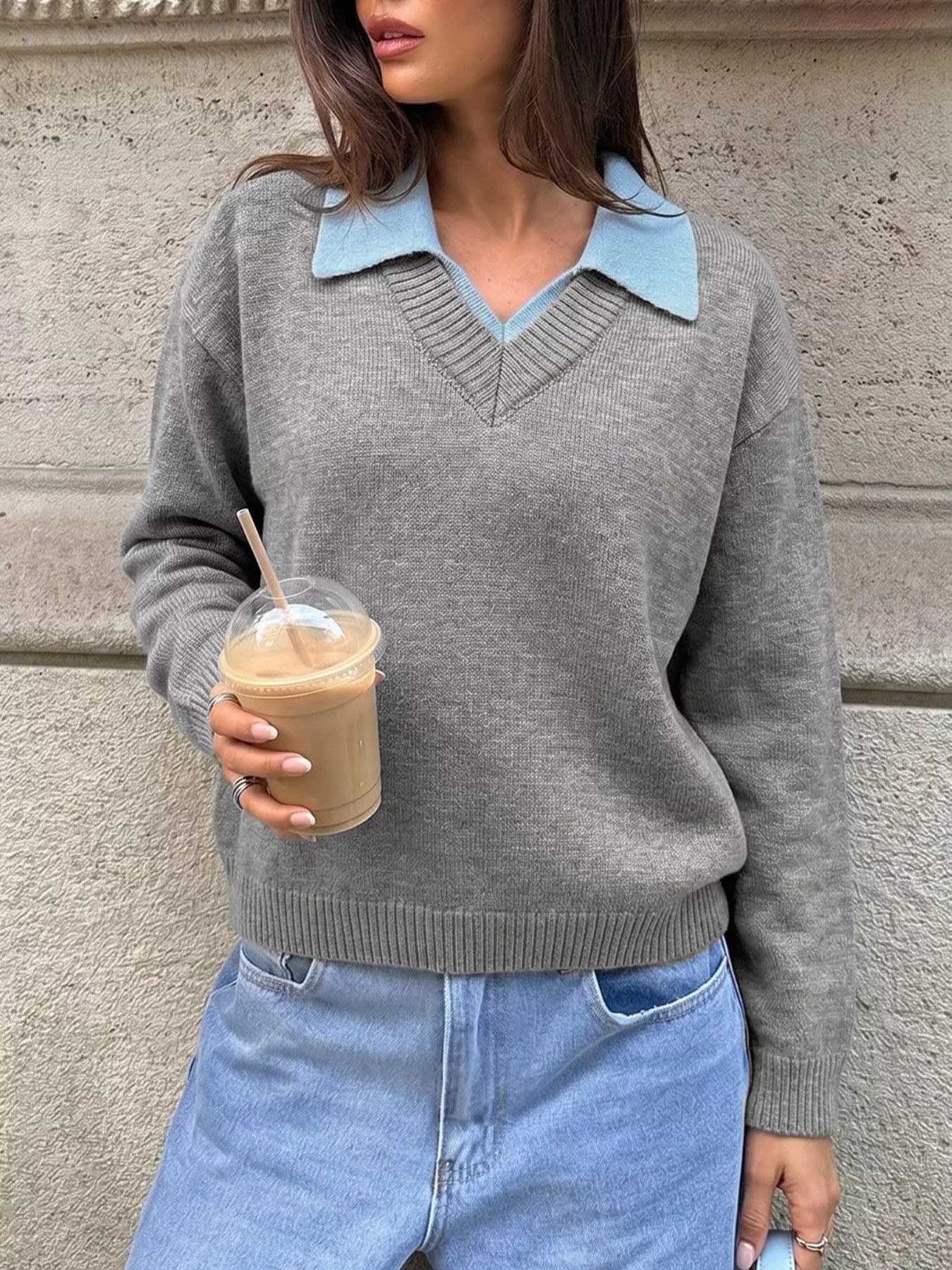 Front view of a gray knit sweater with a light blue polo collar and V neck