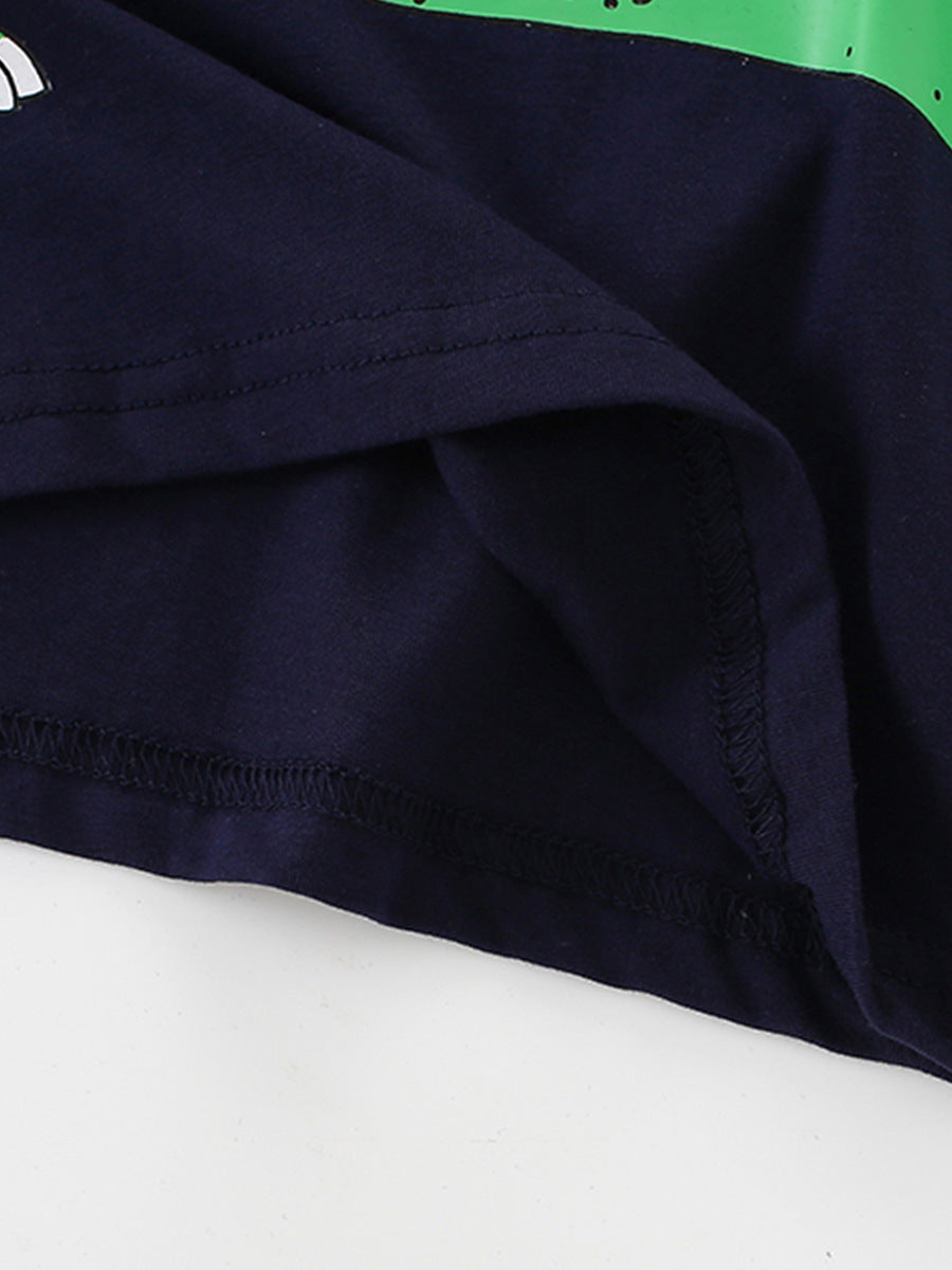Close-up of the hem stitching and inner fabric on a black children's dinosaur graphic T-shirt