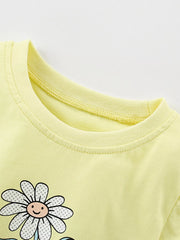 Close view of the light yellow children's tee neckline with a smiling daisy print below it