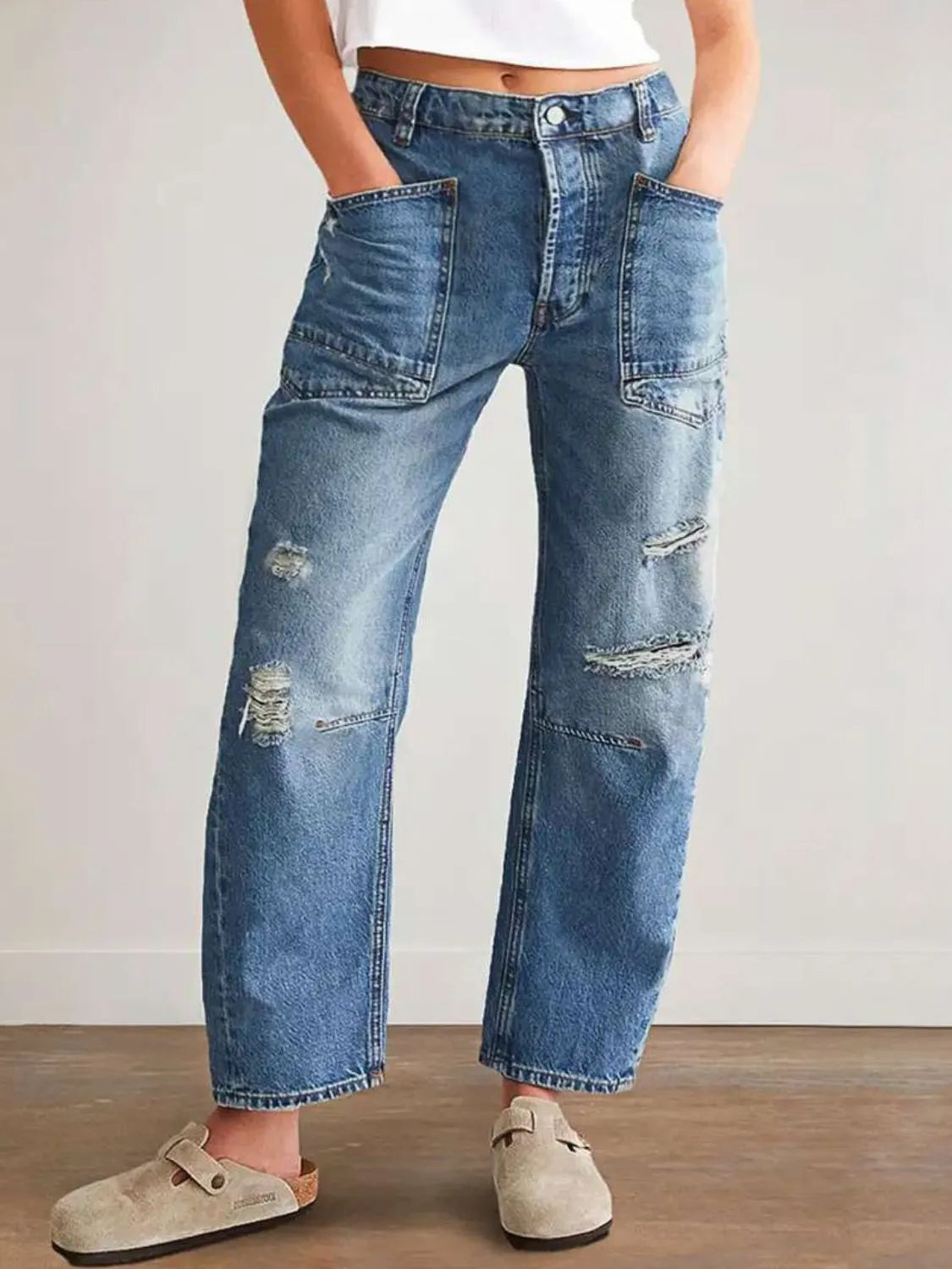 Women's distressed jeans with buttons and pockets in a non-stretch cotton blend.