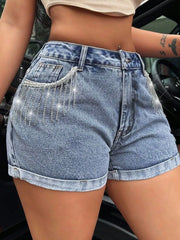 Women's denim shorts with rhinestone fringe, button fastening, and pockets.