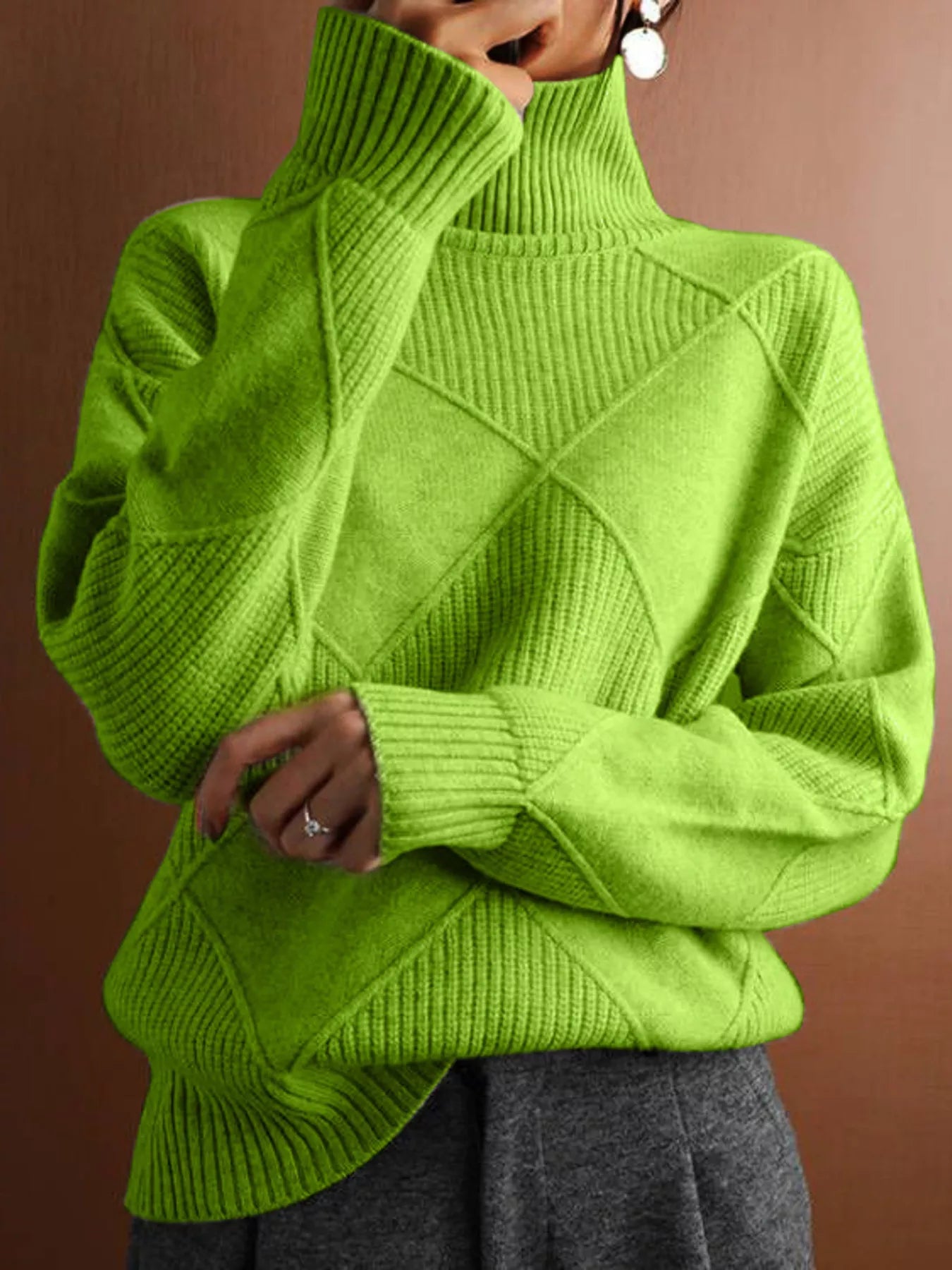 Front torso view of a bright green turtleneck sweater with diamond texture
