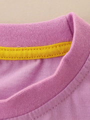 Close-up of the dusty pink neckline with a yellow inner trim and fine stitching