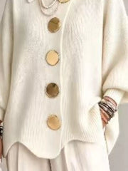 Close up of the cream cardigan lower gold buttons and scalloped hem