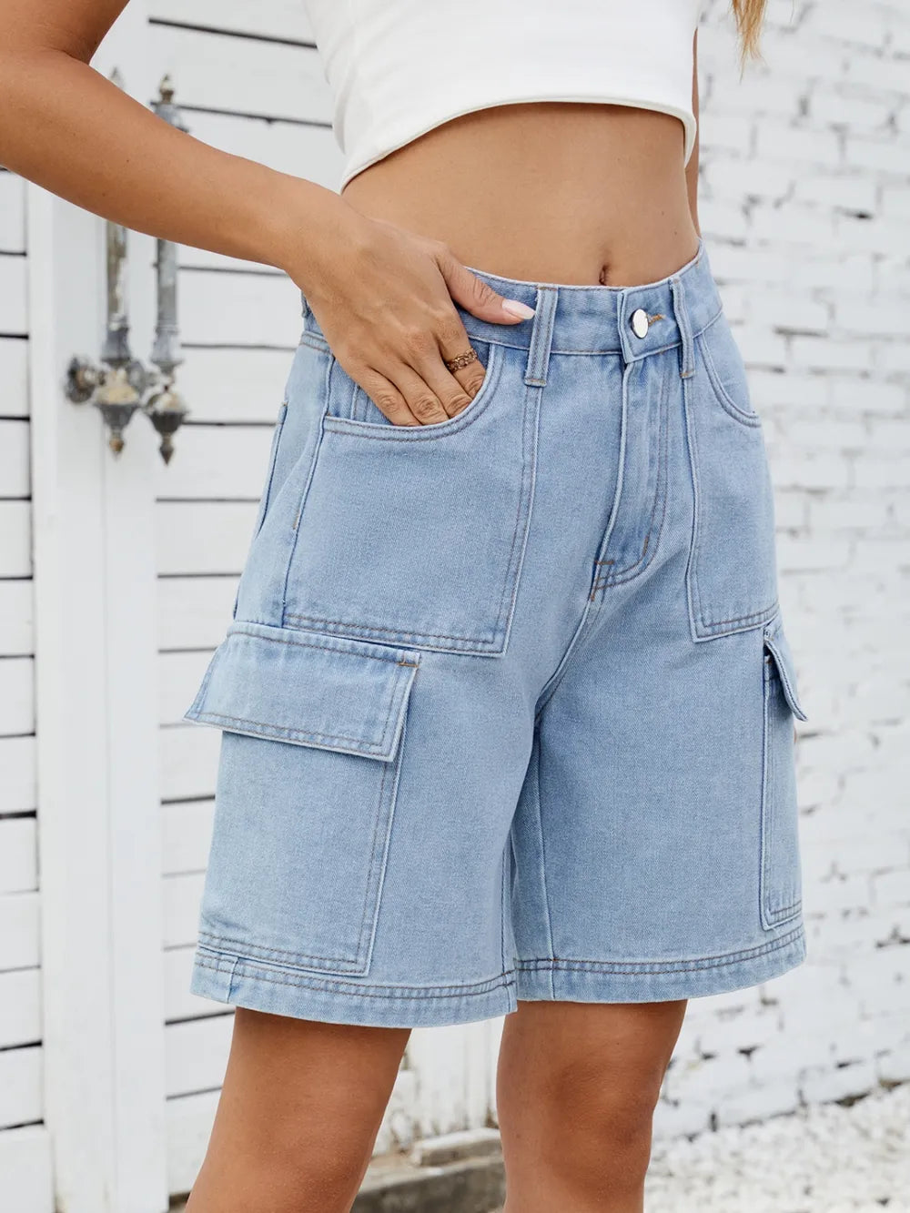 Women's high-waisted denim shorts with cargo pockets in a non-stretch rayon blend.