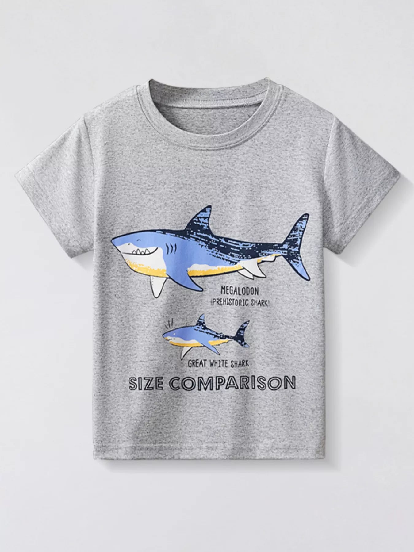 Light gray children's short sleeve T-shirt laid flat with a large megalodon and smaller great white shark