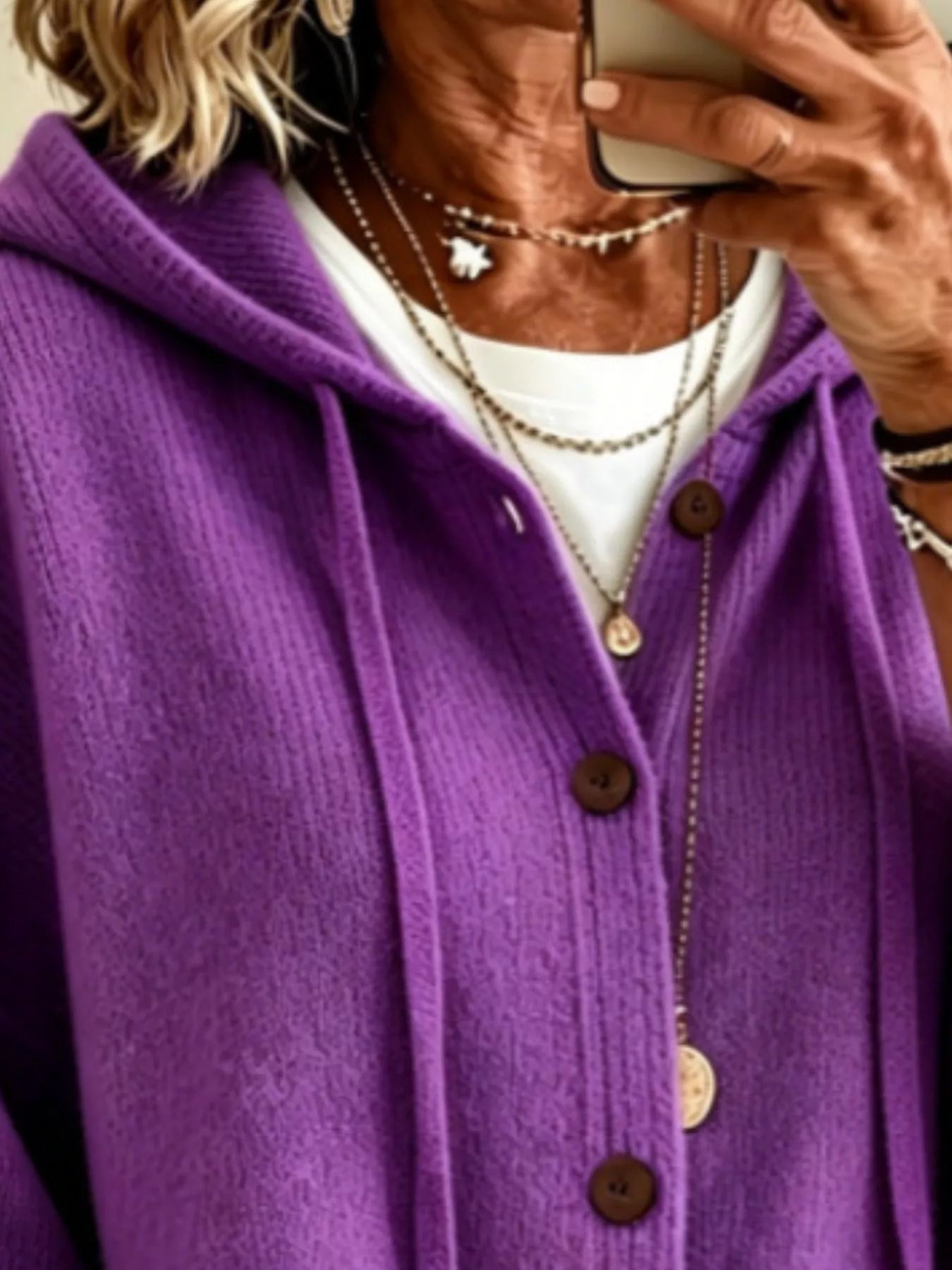 Close view of the purple hooded cardigan showing drawstrings and button front