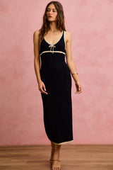 Black and oatmeal sleeveless knit sweater maxi dress in front walking view