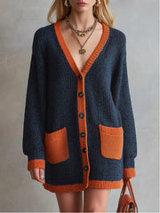 Close up of the navy V neck cardigan showing its orange trim and dark buttons