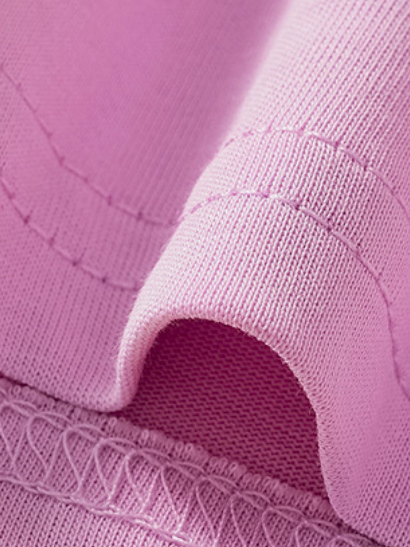 Close-up of the pink sleeve hem and stitching detail on a children's short sleeve tee