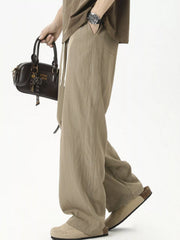 Men's lightweight loose fit casual pants with a drawstring waist.
