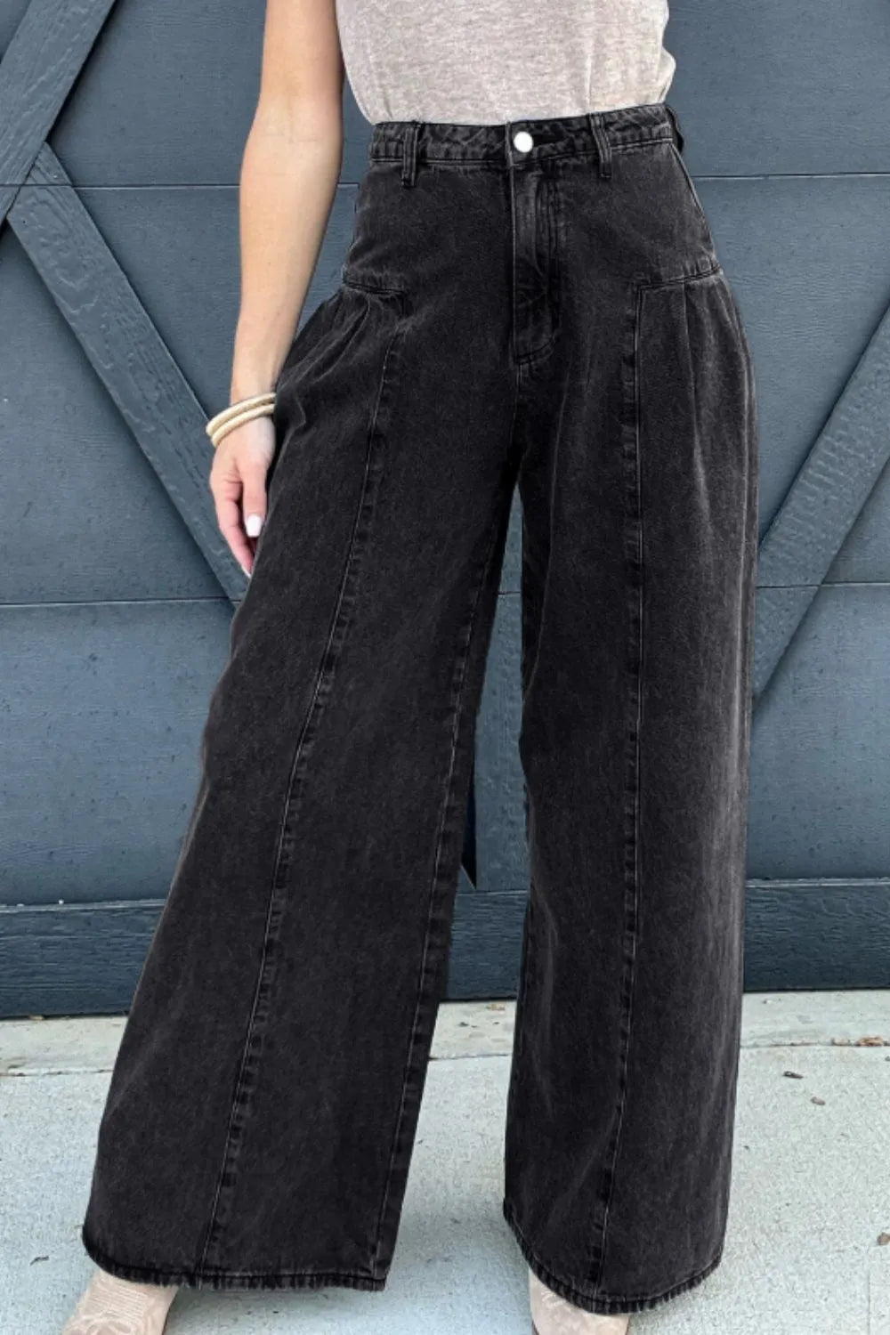 Women's black high-rise wide-leg jeans with pockets in a non-stretch cotton blend.