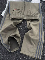 Men's striped wide leg pants with a drawstring waist and pockets.