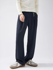 Men's wide leg pants with a drawstring waist and pockets.