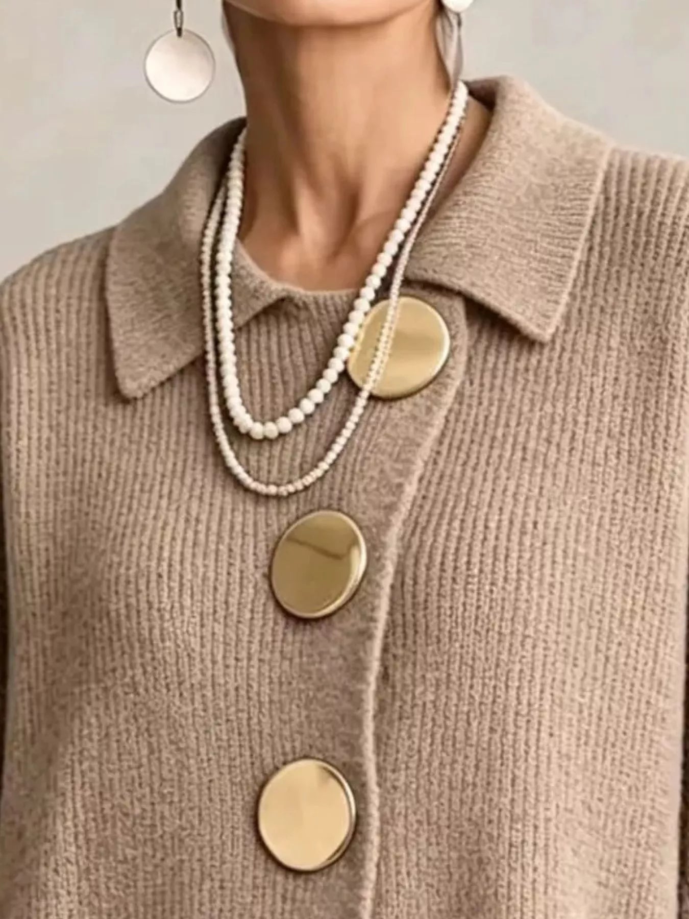 Close up of the khaki cardigan collar and large gold front buttons