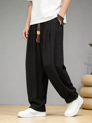 Men's loose fit casual pants with a drawstring waist and pockets.