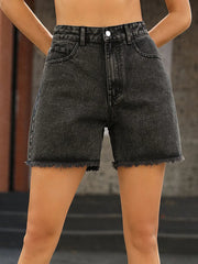 Women's high-waisted denim shorts with raw hems, buttons, and pockets.