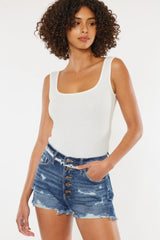Women's distressed denim shorts with a button fly, raw hems, and pockets.