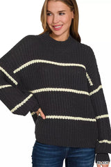 Black oversize striped sweater with cream stripes worn with dark jeans studio
