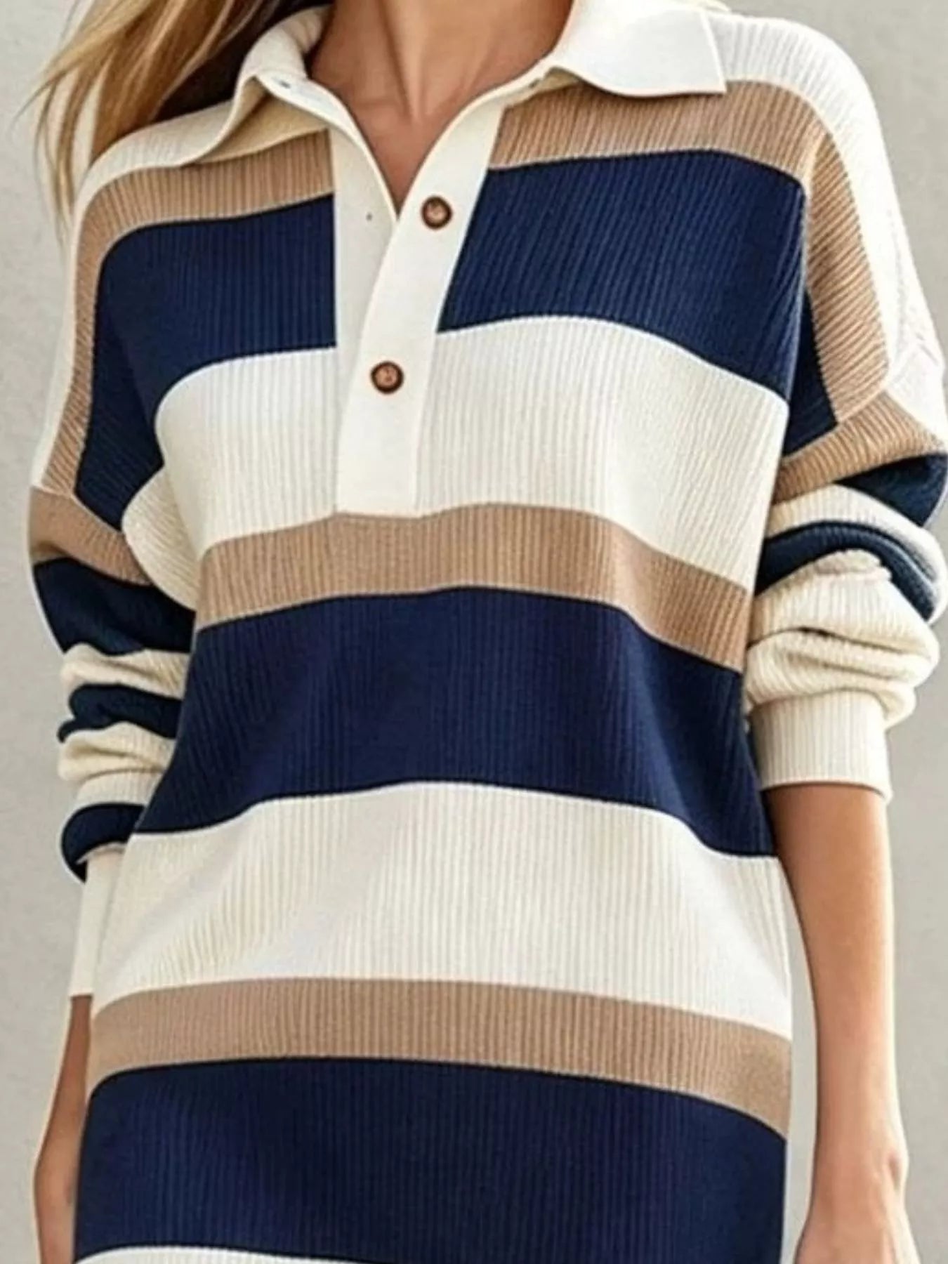 Closeup of navy striped sweater dress bodice showing polo collar and button placket