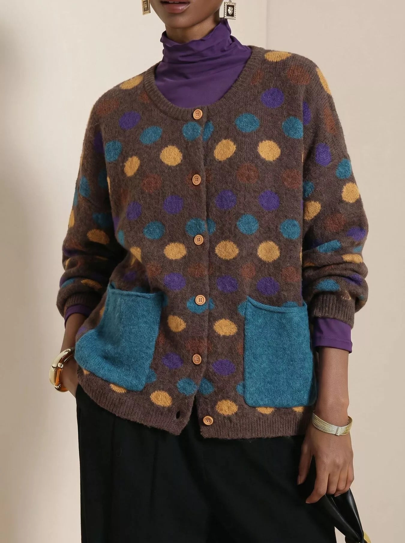 Coffee brown polka dot cardigan with buttons and teal pockets on model