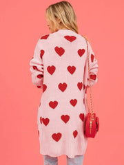 Back view of the pink longline cardigan covered in a red heart pattern