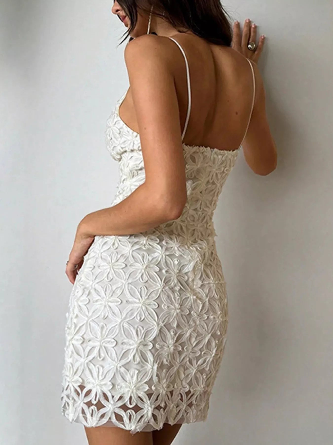 White floral lace bodycon mini dress, back and side view against wall
