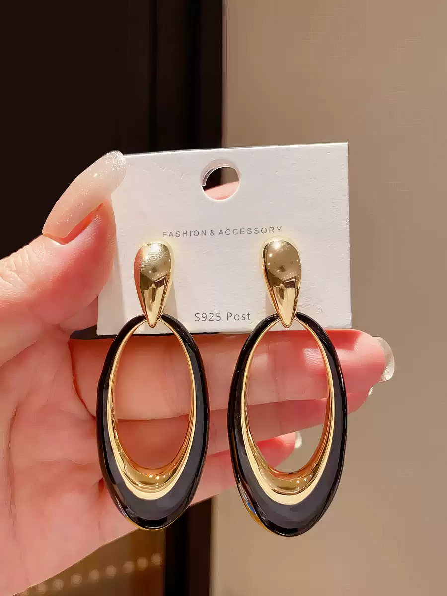 Contemporary Gold Tone Drop Earrings with Elongated White Smooth Oval Inlay