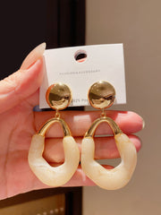 Stylish Gold Tone Drop Earrings with Round Top and Irregular Creamy White Geometric Inset