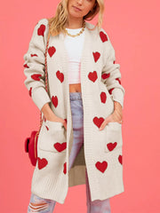 Front view of a cream longline cardigan with red hearts and patch pockets
