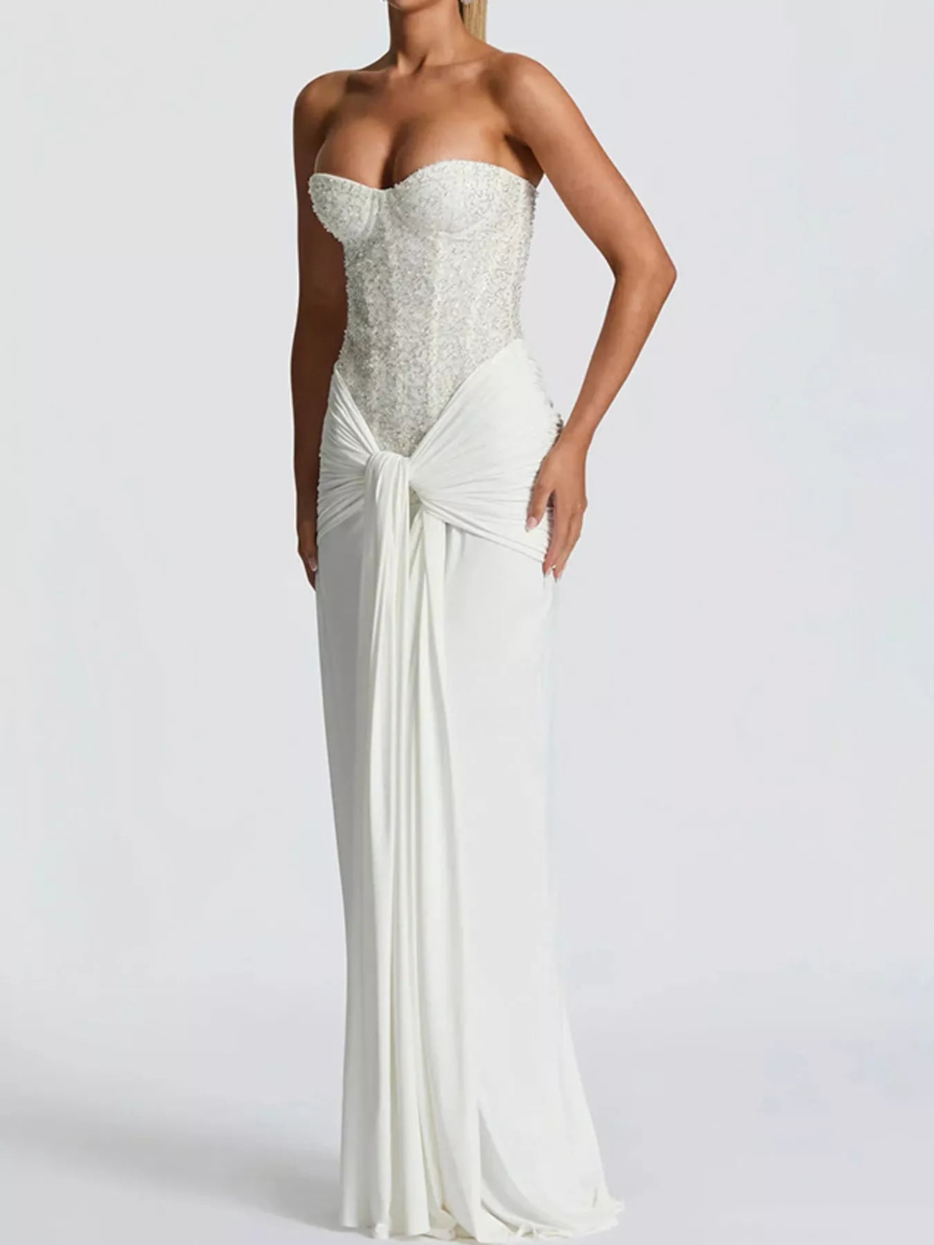 White strapless sequin corset maxi dress on model, three quarter front view in studio