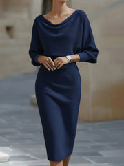 Front view of a navy blue cowl neck knit bodycon dress with wide batwing sleeves