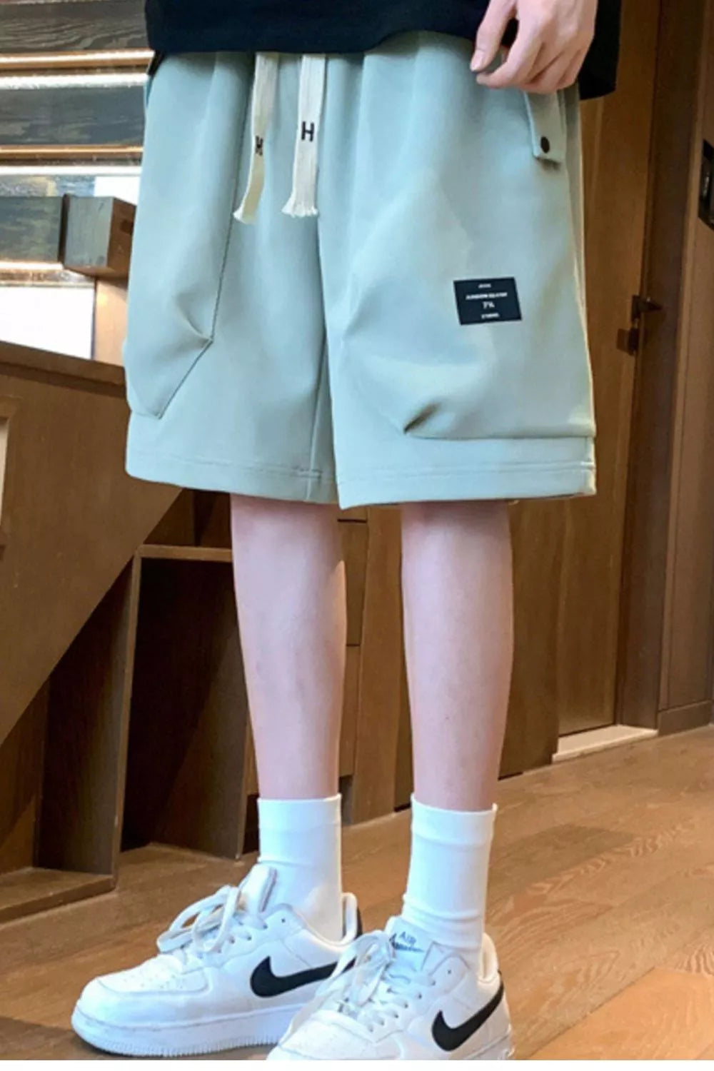 Men's lightweight shorts with a drawstring waist and pockets.