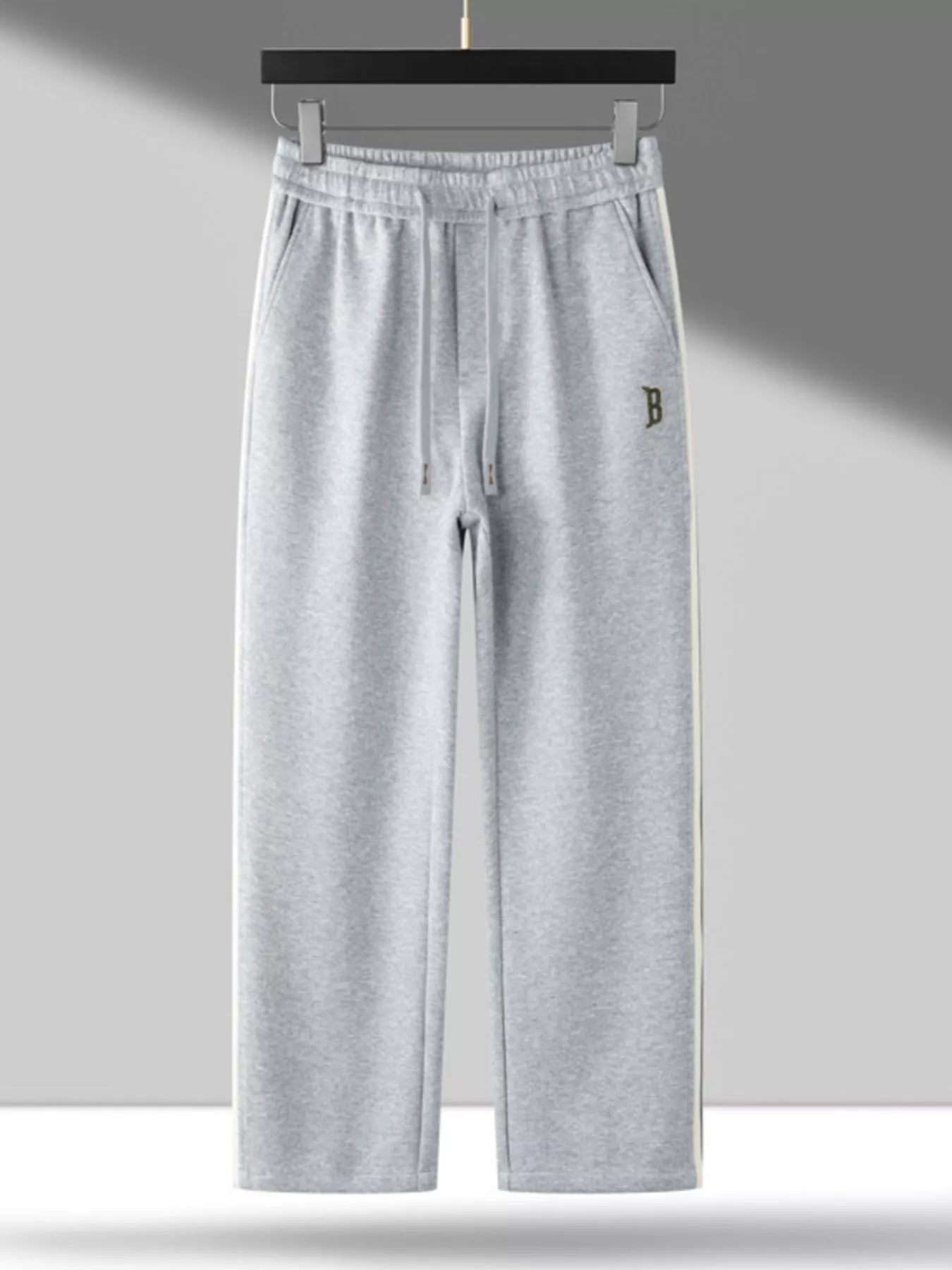 Men's side striped casual pants with a drawstring waist and pockets.