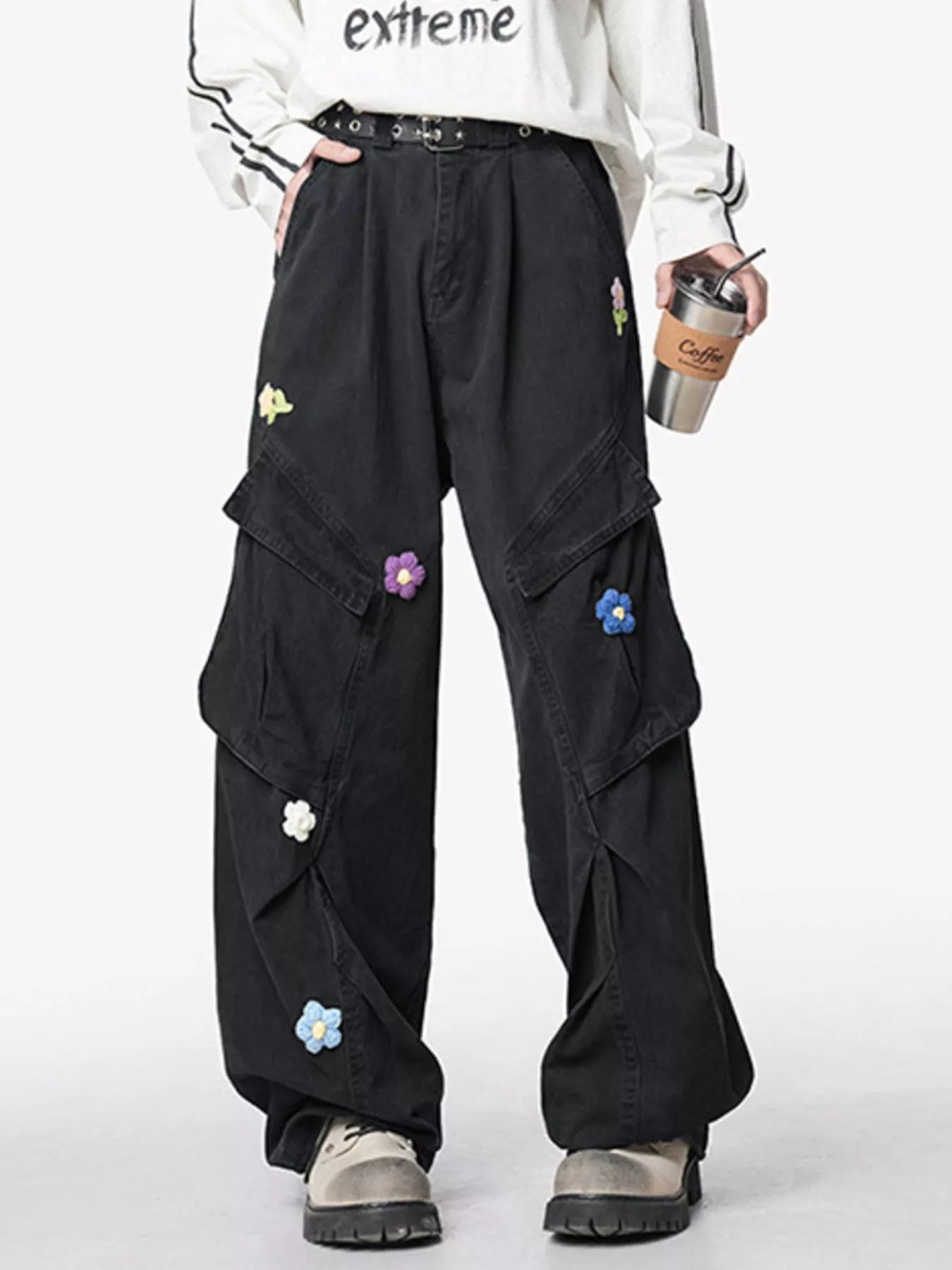Men's black wide-leg pants with an oversized fit and pockets.