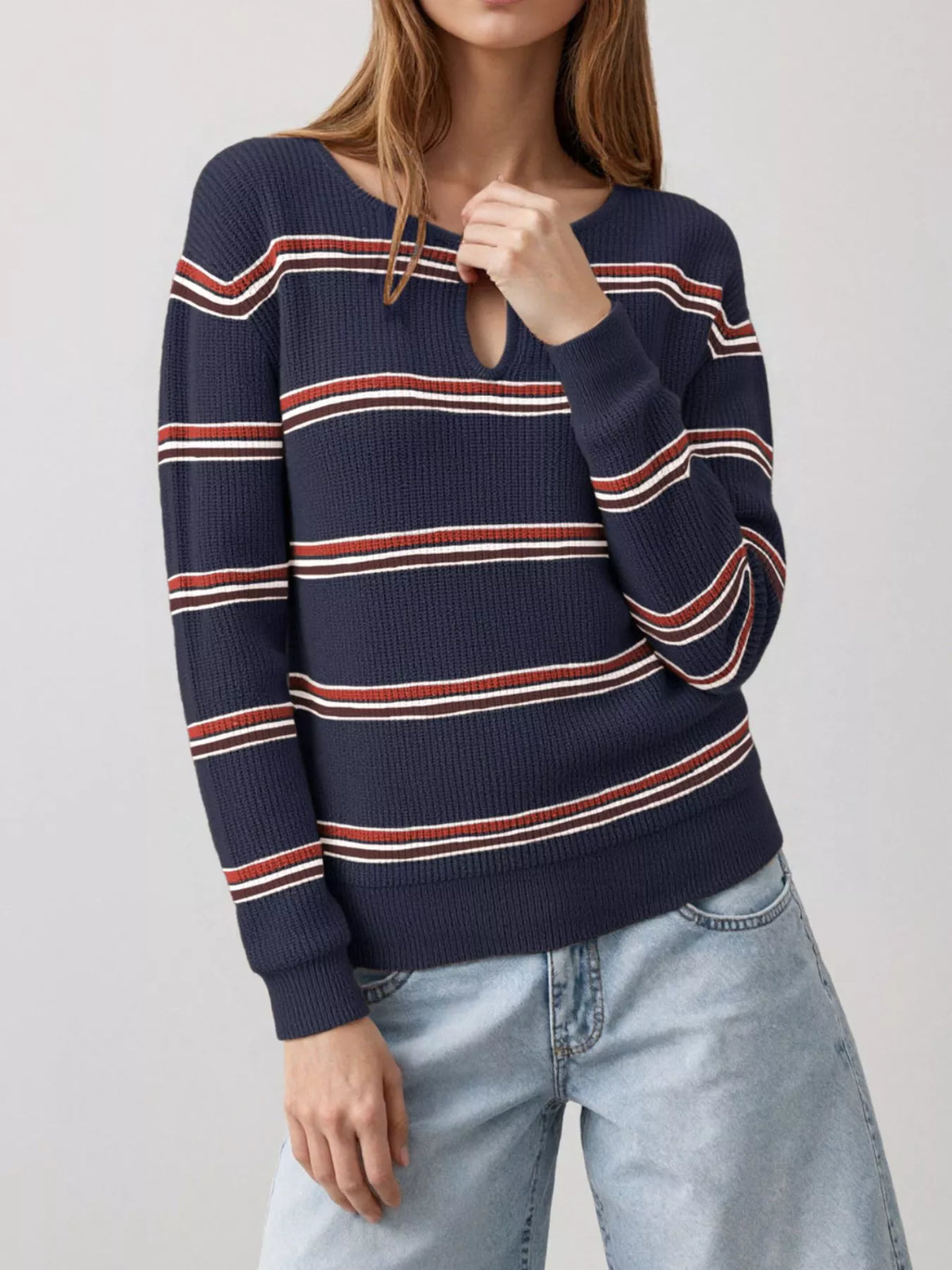 Front view of a dark blue striped ribbed knit top with a keyhole neckline