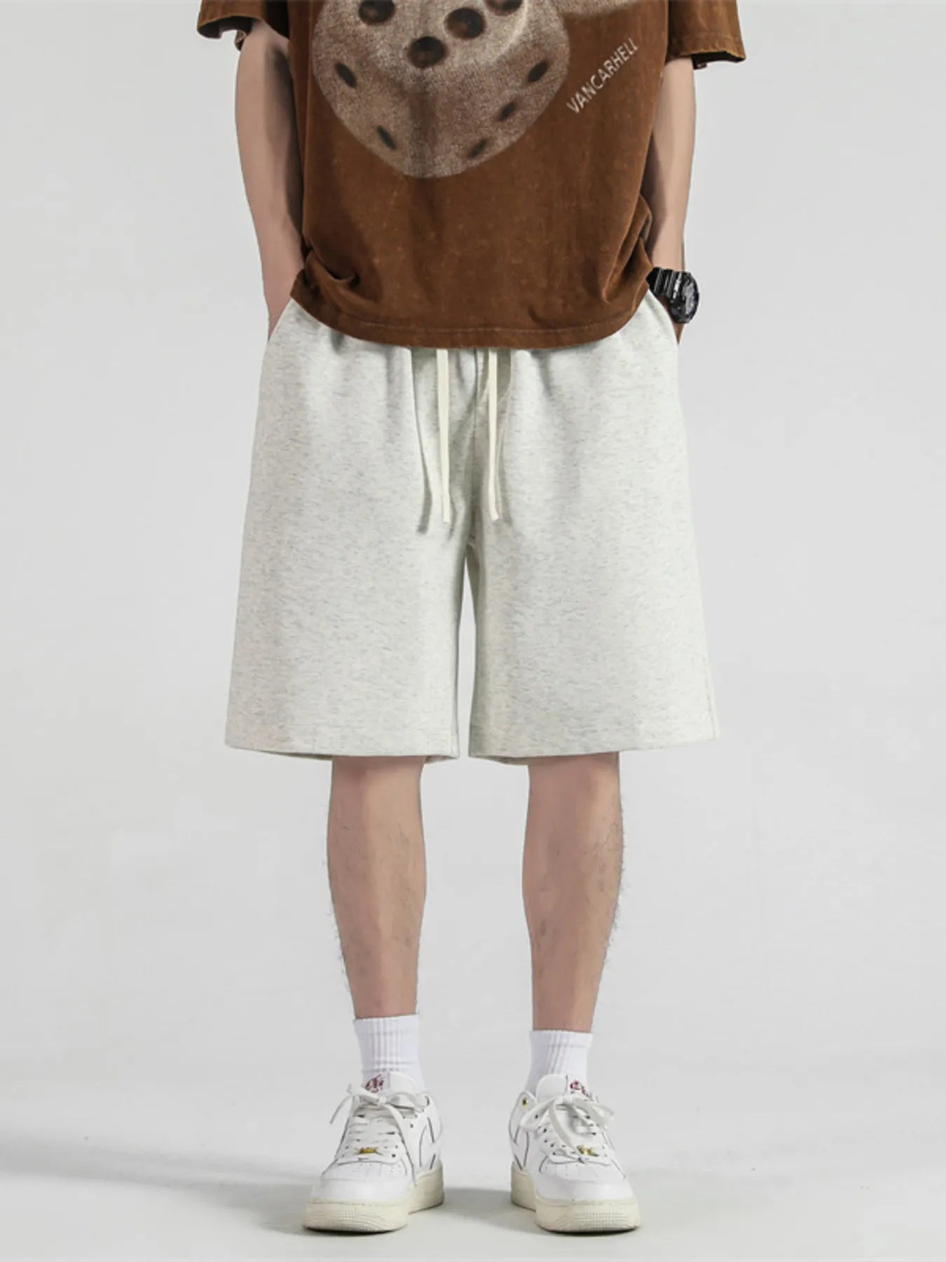 Men's light apricot loose-fit casual shorts with a drawstring waist.