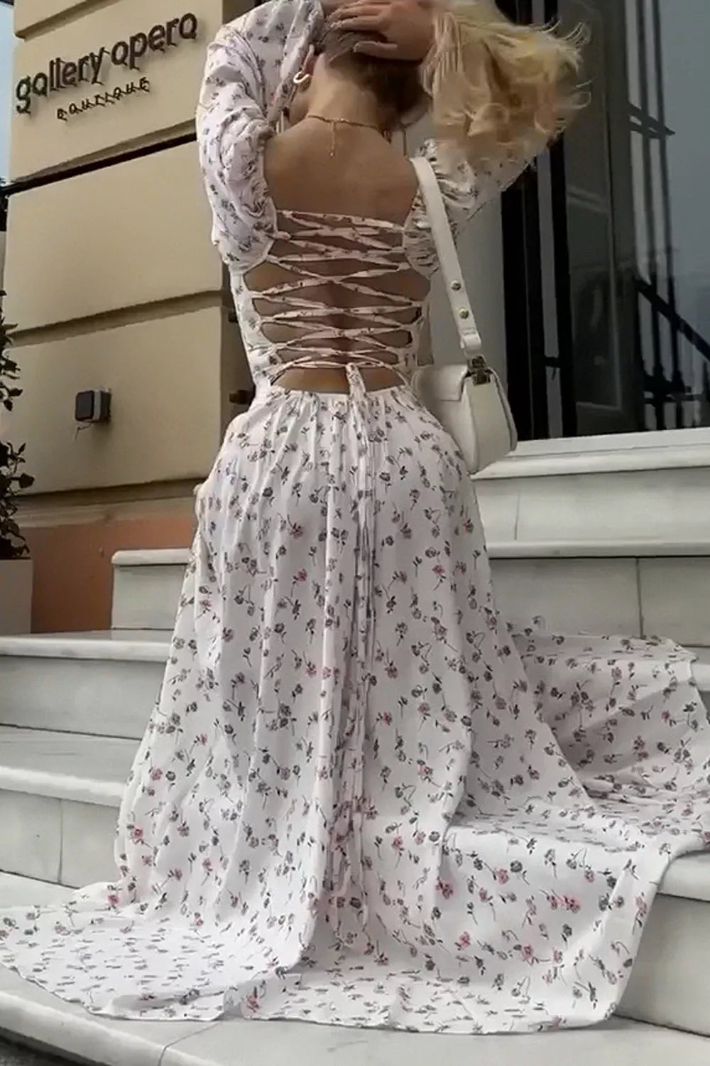 Back view of floral print maxi dress showing lace up back and flowing skirt