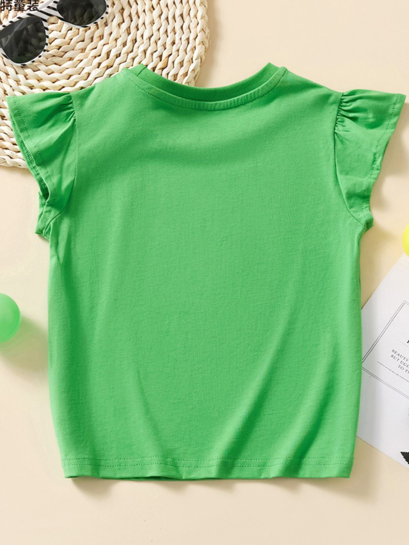 Back view of the plain green children's cap sleeve T-shirt with gathered sleeve edges