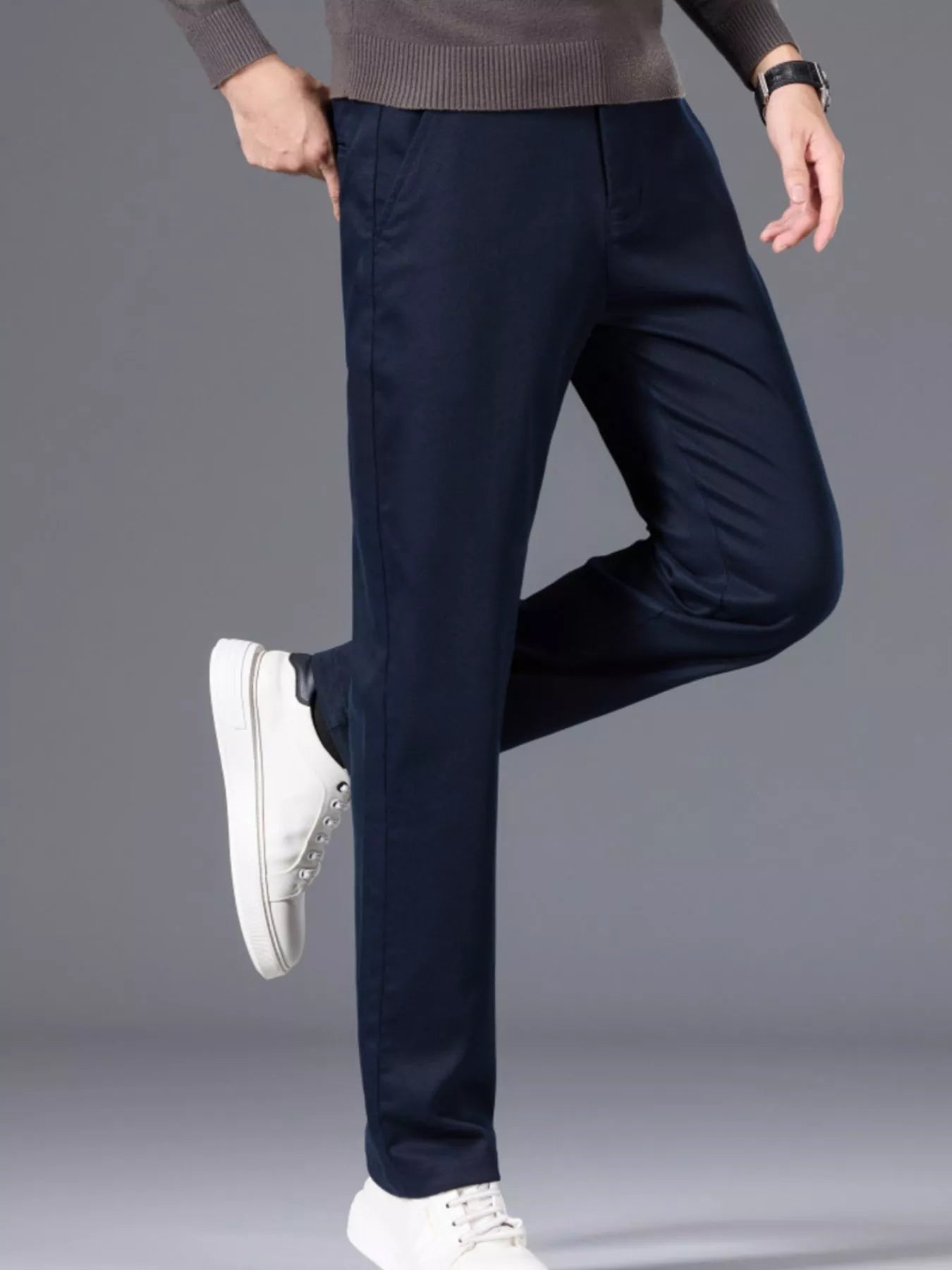 Men's navy slim-fit pants made from cotton with pockets.