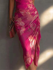 Close view of the ruched rose red floral midi skirt with a side slit and gathered waist detail