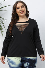Plus-size woman wearing a black long-sleeve T-shirt with a triangular cutout front detail