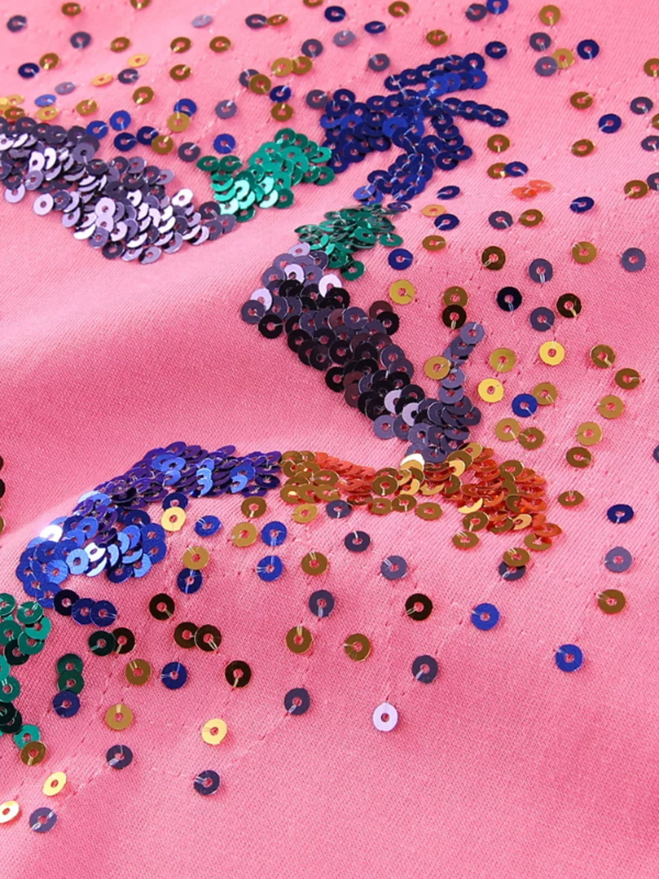 Close-up of multicolor sequin star detail on fuchsia pink children's round neck tee