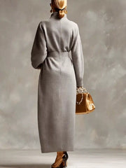 Back view of a grey waffle knit long sleeve midi dress with a centre back seam
