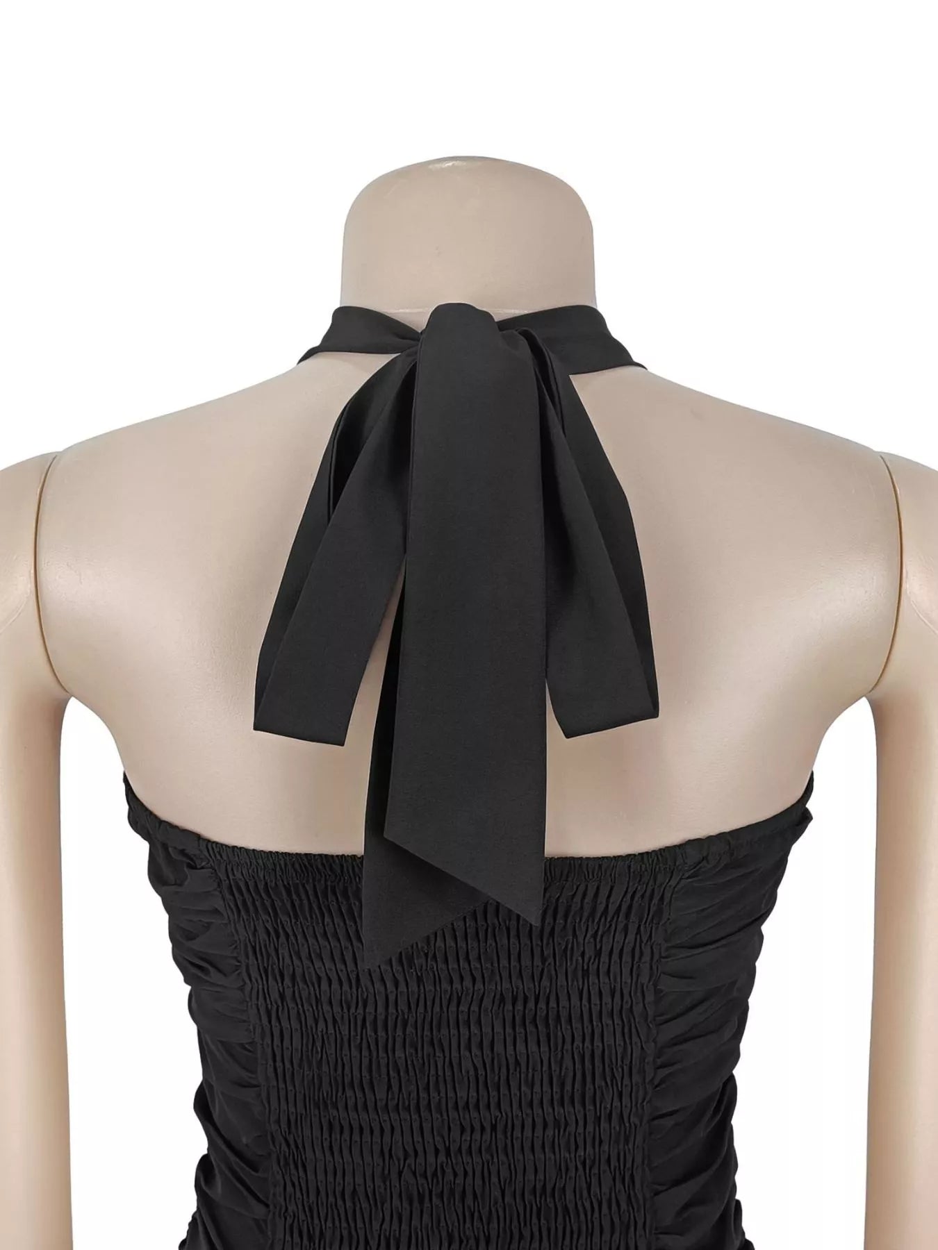 Close back detail of black halter maxi dress showing tied neck strap and smocked bodice