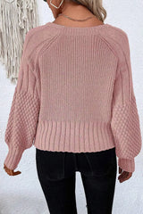 On-model back view of a dusty pink V-neck cardigan with ribbed knit and textured sleeves