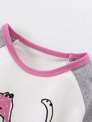 Close-up of the pink crew neckline and gray raglan sleeve on the white children's shirt