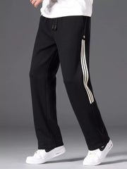Men's black striped wide-leg pants with a drawstring waist and pockets.
